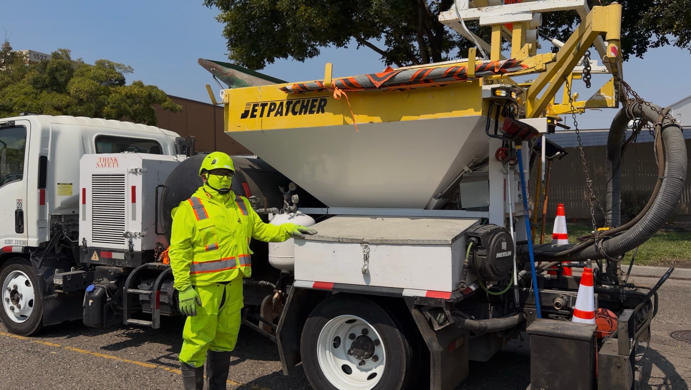 Operator beside the machine with the hopper visible
