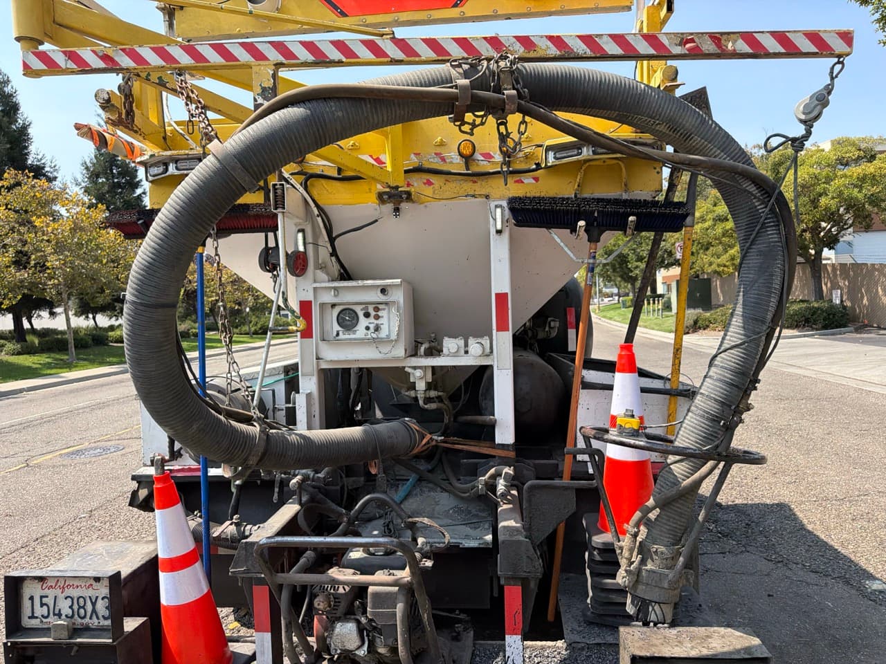 Machine rear view showing hopper and hose