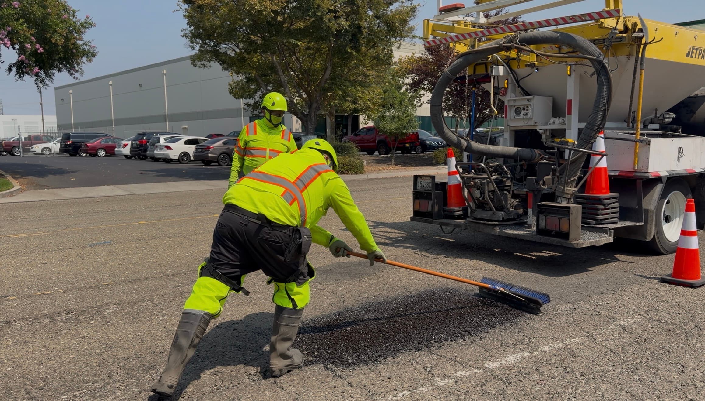 Operator brooming a finished repair