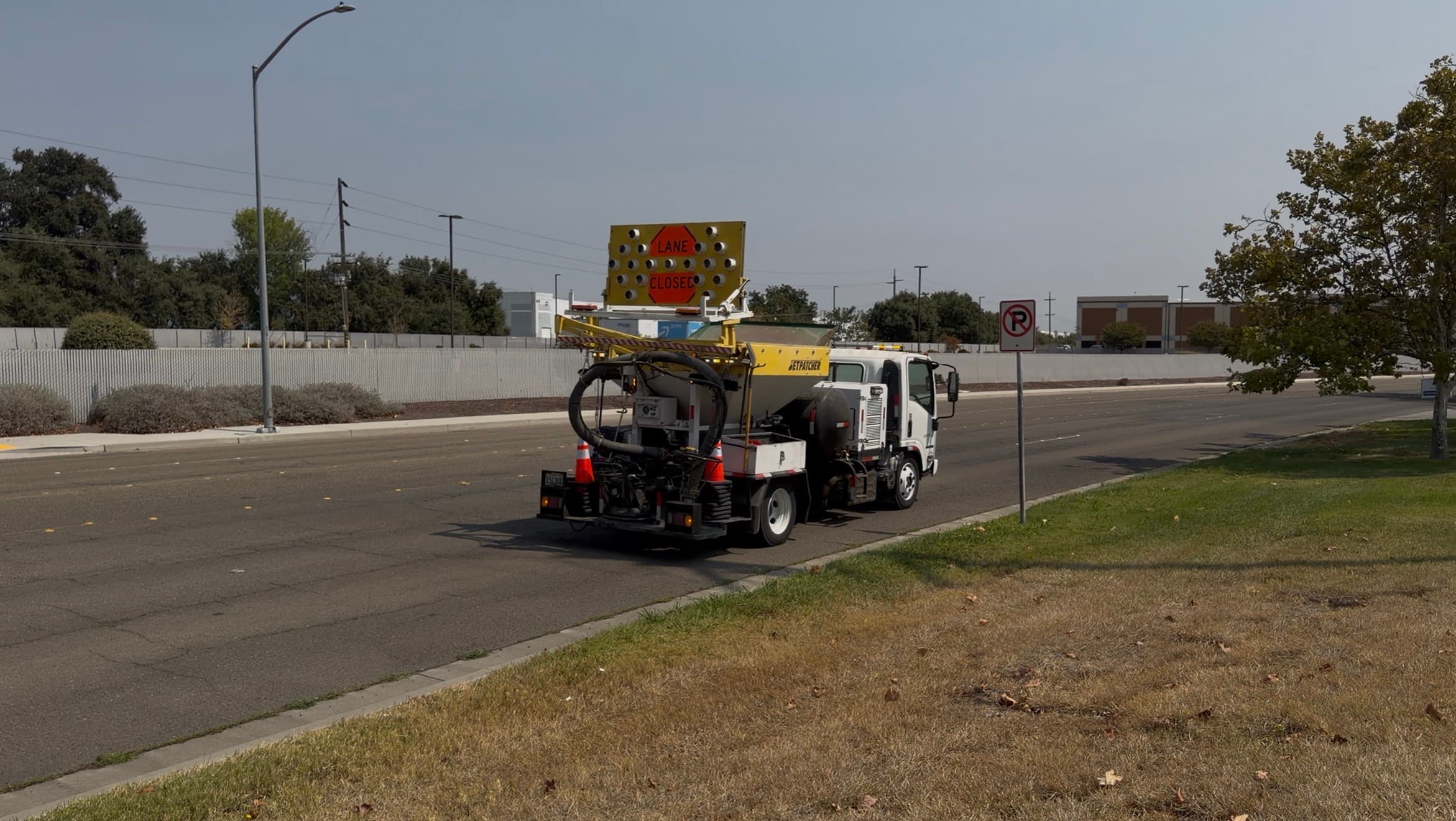 Machine with lane closure signage on a public street