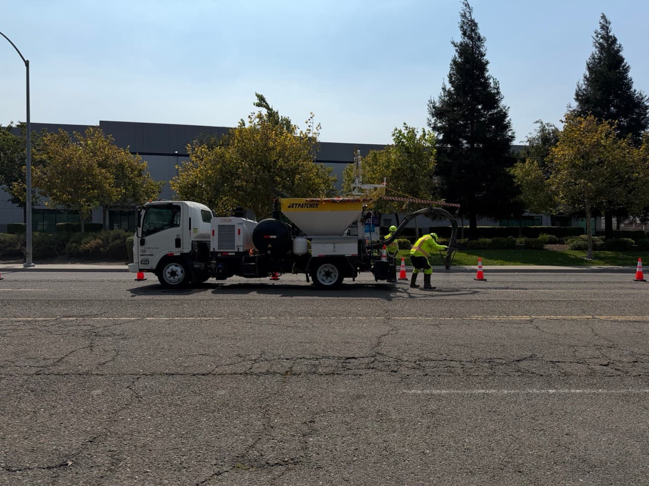 Crew and machine staged at a municipal job site